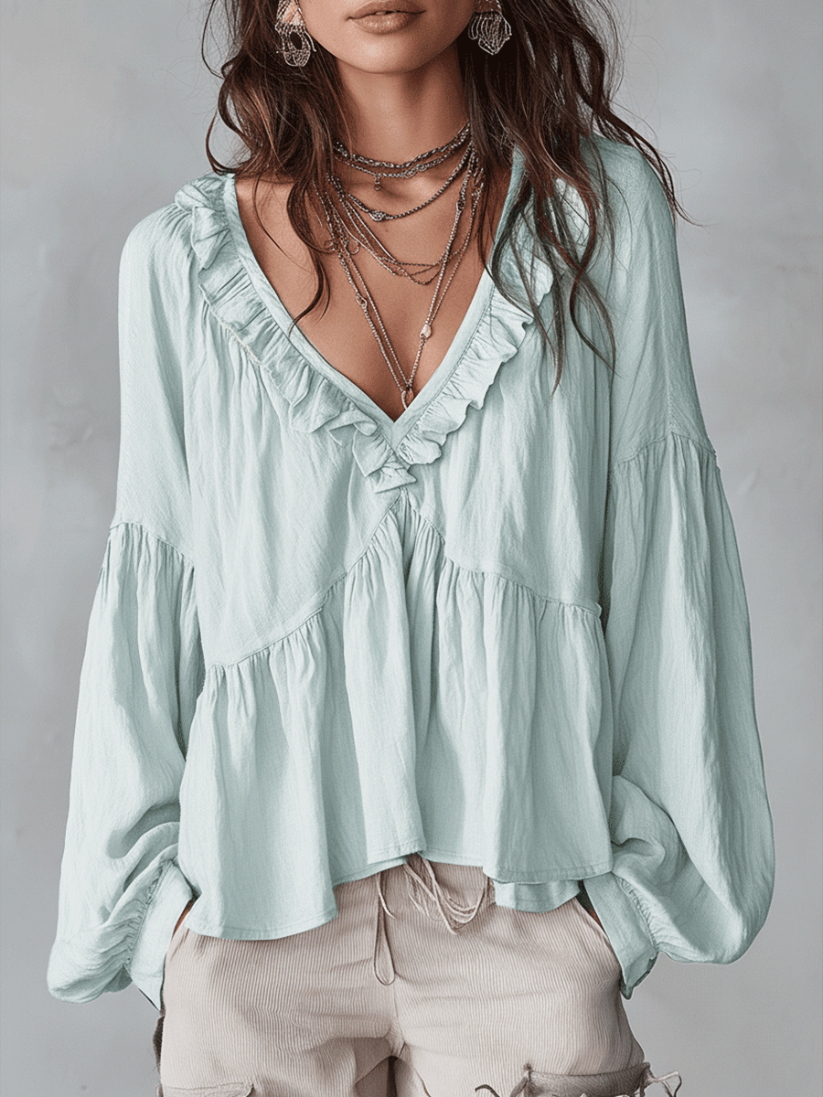 Vintage-inspired bohemian blouse in light green, front view on model