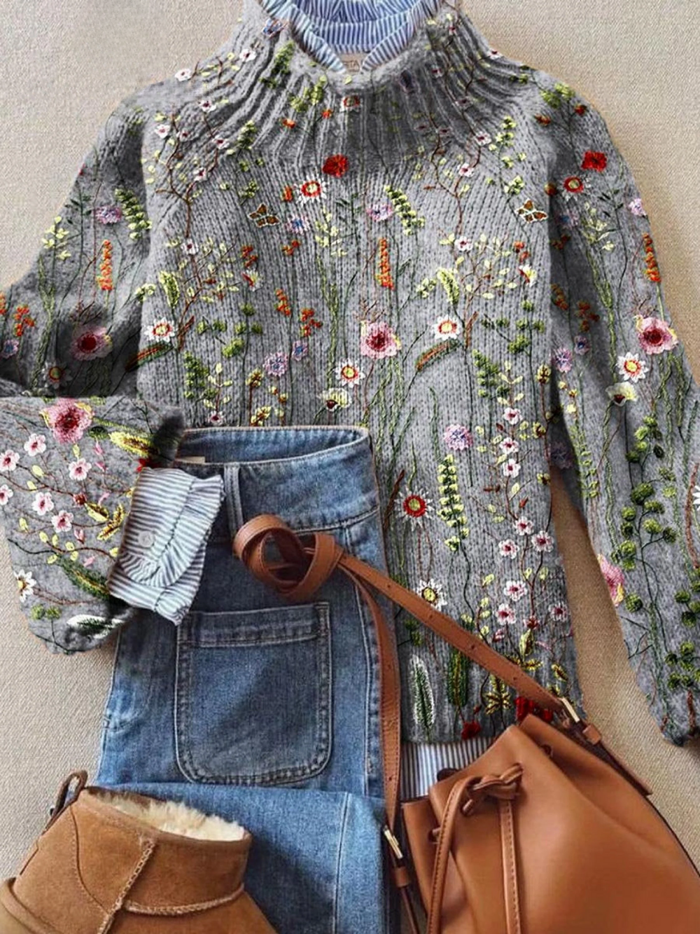 Orvella sweater in grey with colourful wildflower motifs, styled flat with jeans and bag