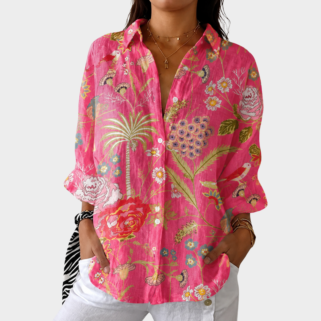 Lightweight colourful print blouse in pink, front view worn with white trousers