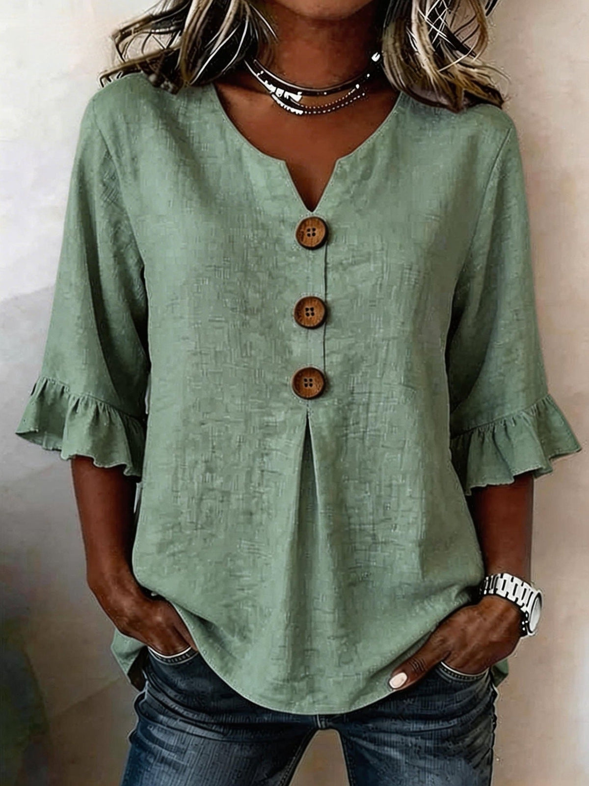 Jessara ruffle-sleeve blouse in olive green, front view worn with denim