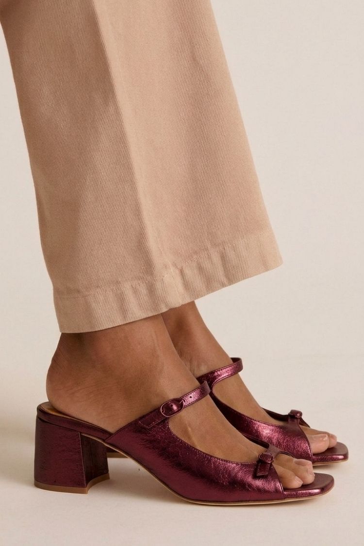 Valentina heeled sandals in plum metallic, side view on model