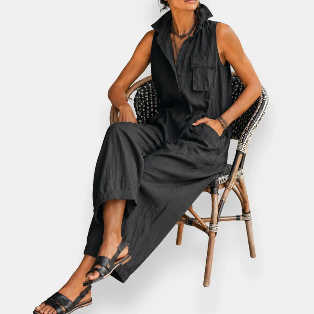 Ryker sleeveless cargo jumpsuit in black, seated view showing collar and chest pocket
