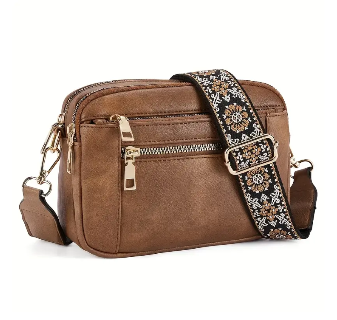 Strap crossbody bag in brown with floral woven strap, side view