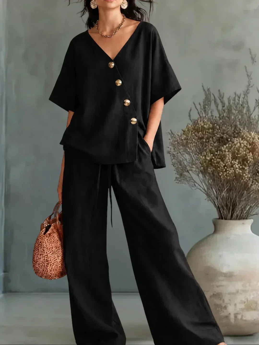 Celia V-neck button set in black, full-length front view
