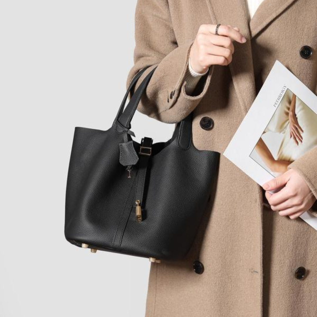 Kate lock bag in black, front view held in hand