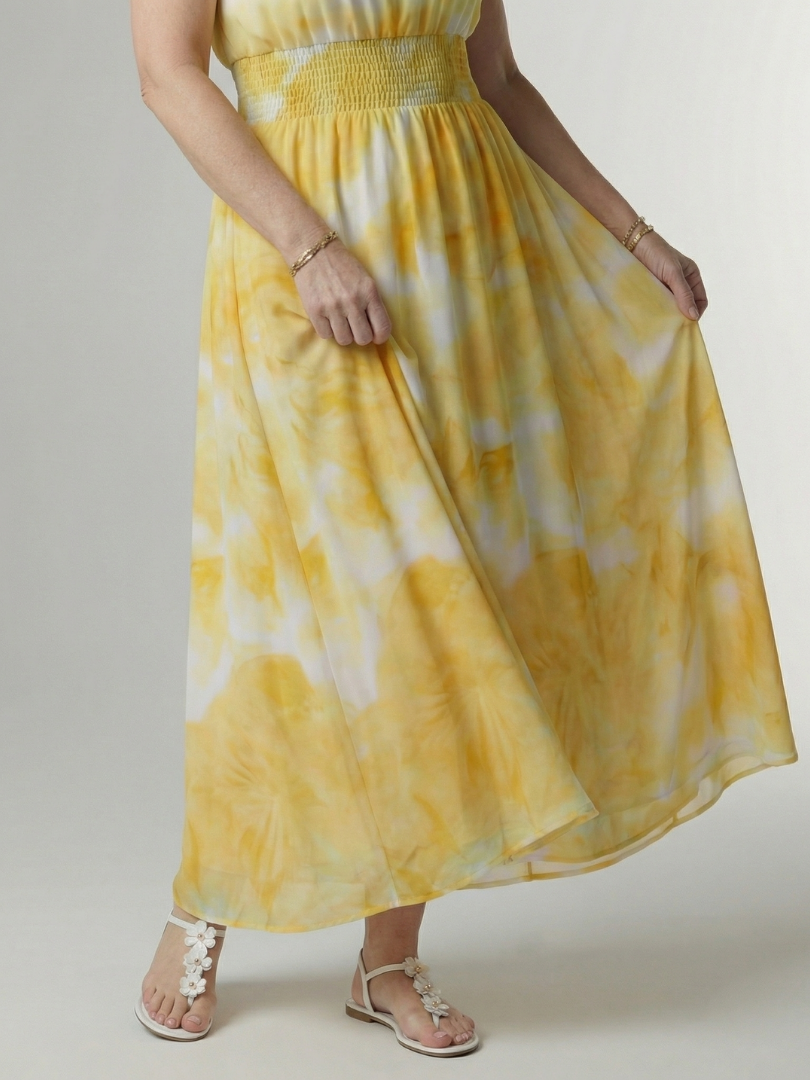 Sylin dress in yellow, close-up of smocked waist and gathered skirt
