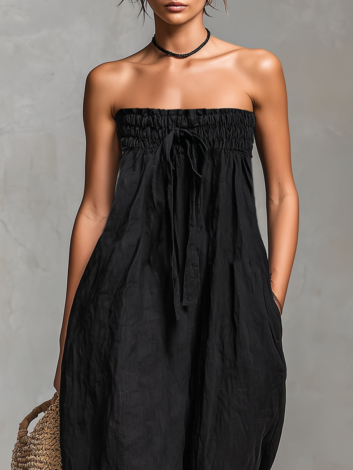 Nina strapless jumpsuit in black, close-up of shirred bodice and front tie