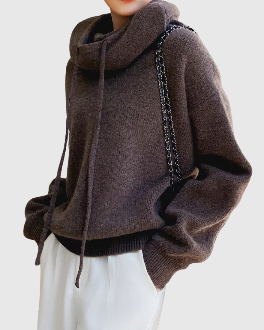 Calyssia knitted hoodie in brown, side view with relaxed sleeves