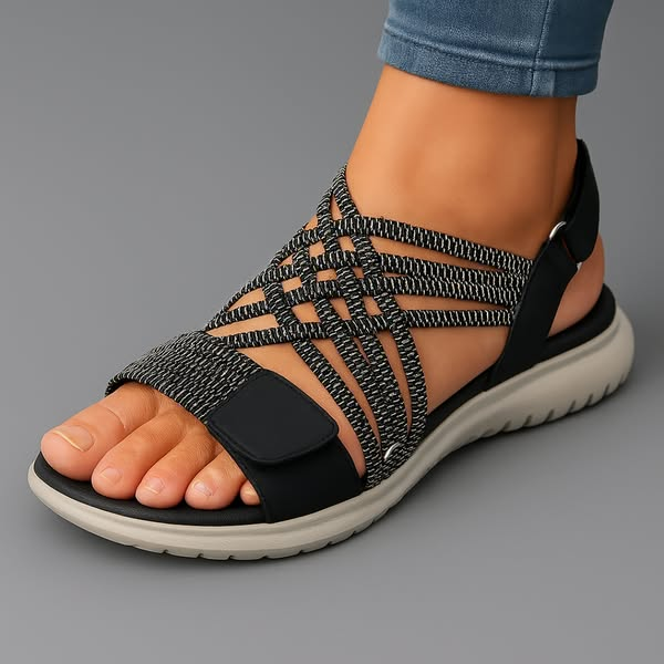 Sanarita sandals in black, worn side view with adjustable tab