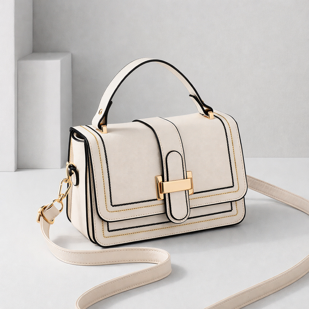 Luna Paris structured shoulder bag in cream with gold buckle, front angled view