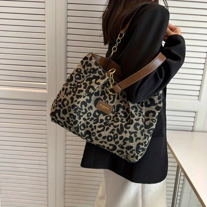Tavira leopard tote bag worn over the shoulder, side view