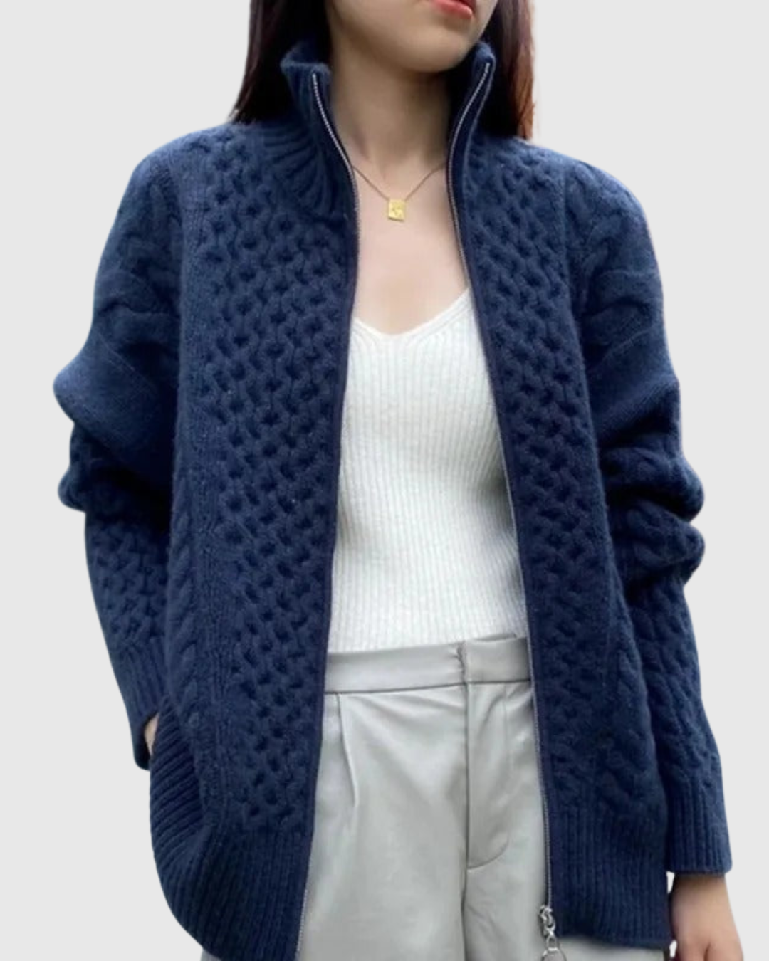 Evarine cable-knit cardigan in navy, worn open over white top