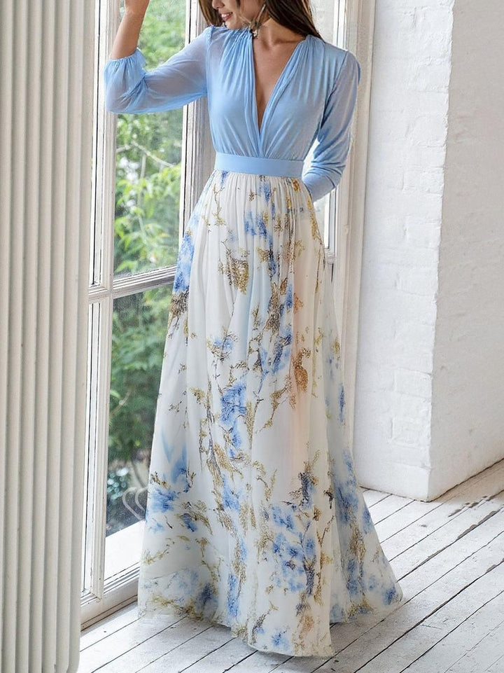 Sarah floral maxi dress by a window, showing gathered bodice and printed skirt