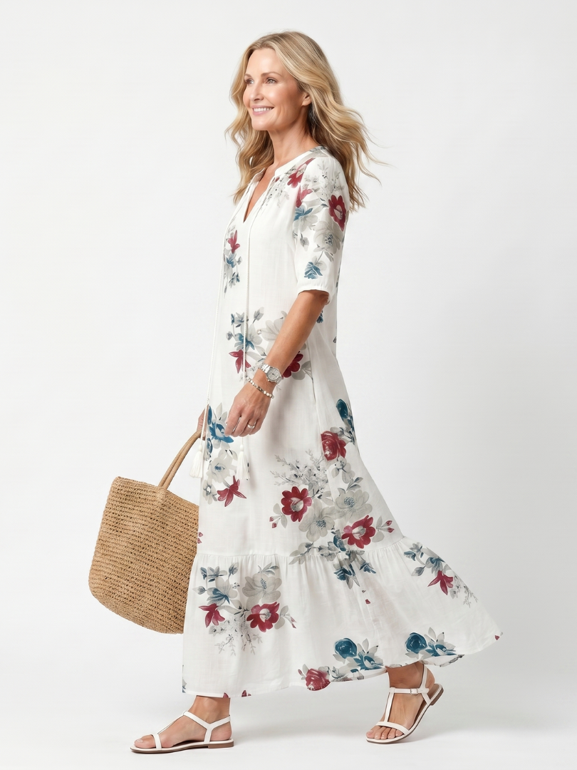 Maeva floral midi dress in white, side view walking with straw tote