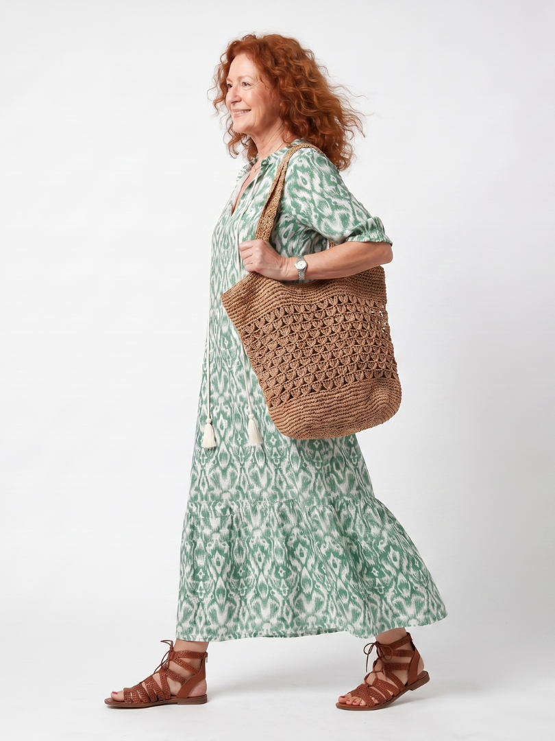 Ilara midi dress in green ikat print, side view while walking