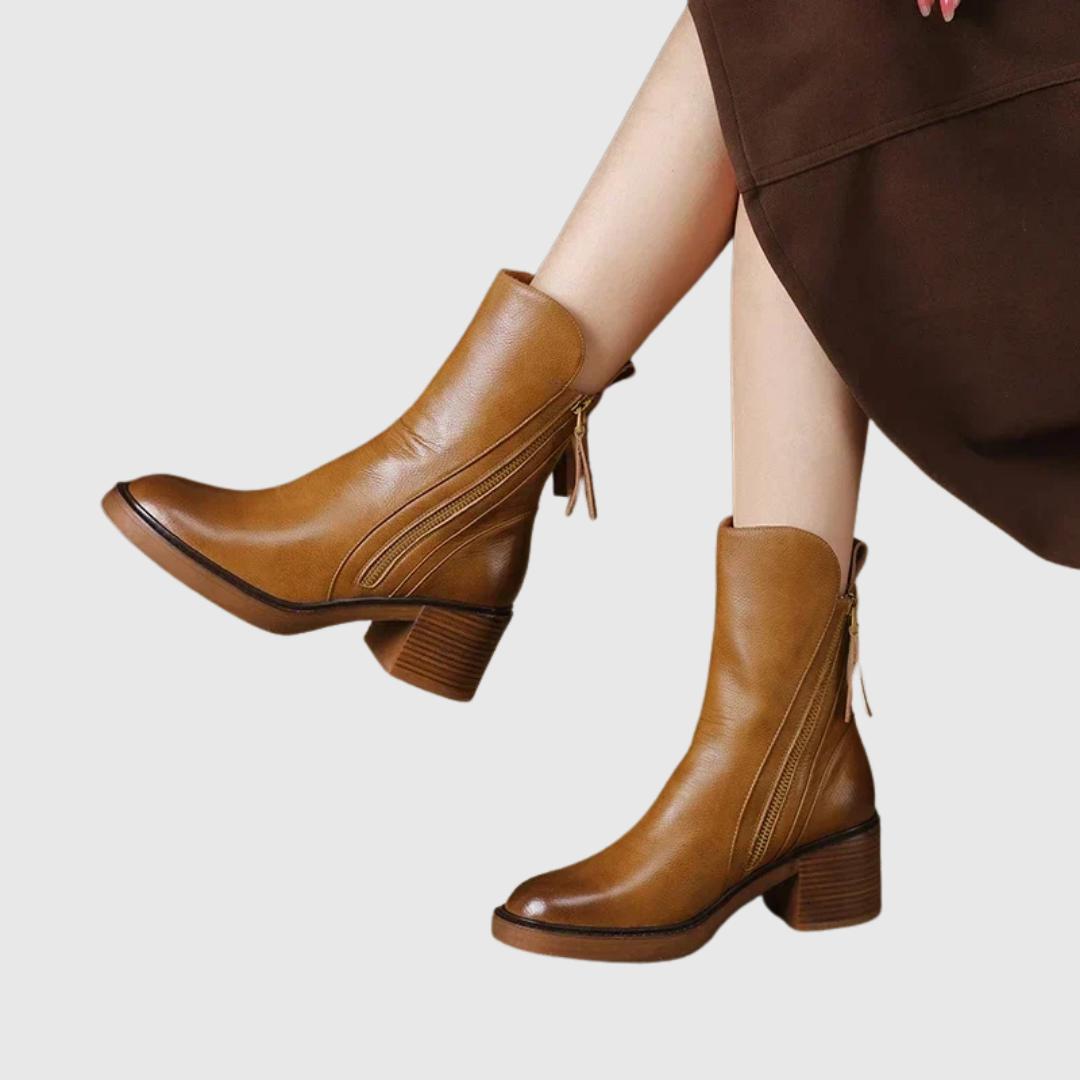 Streamlined ankle boots in brown worn with a skirt, side view