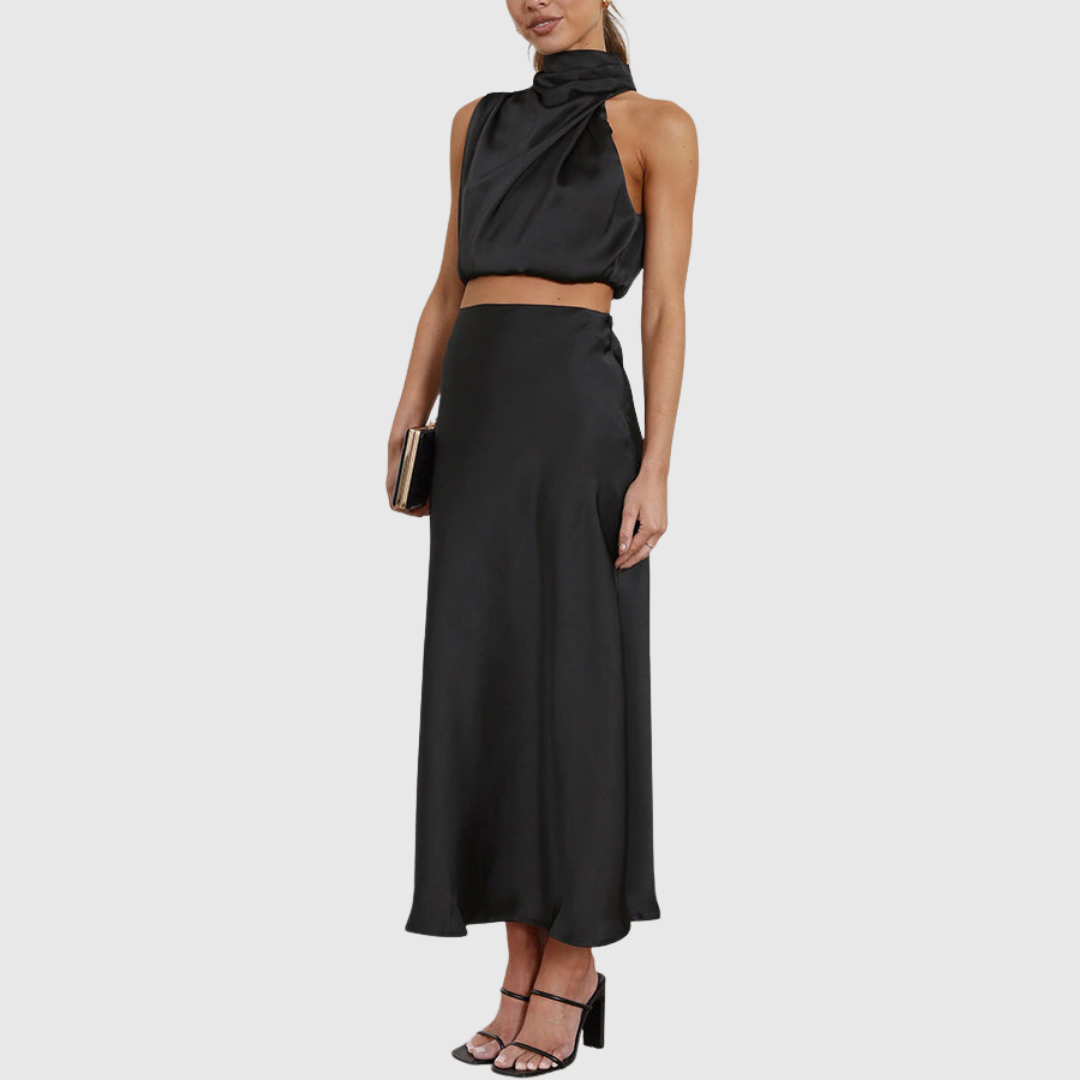 Emily black satin set shown from the side with clutch and heels