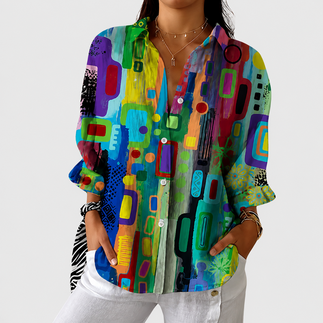 Printed relaxed fit blouse in multicoloured abstract print, front view worn with white trousers