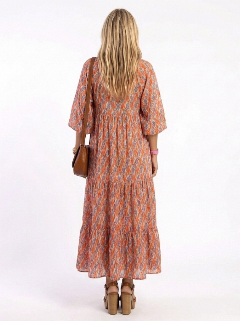 Amara geometric midi dress in coral, back view