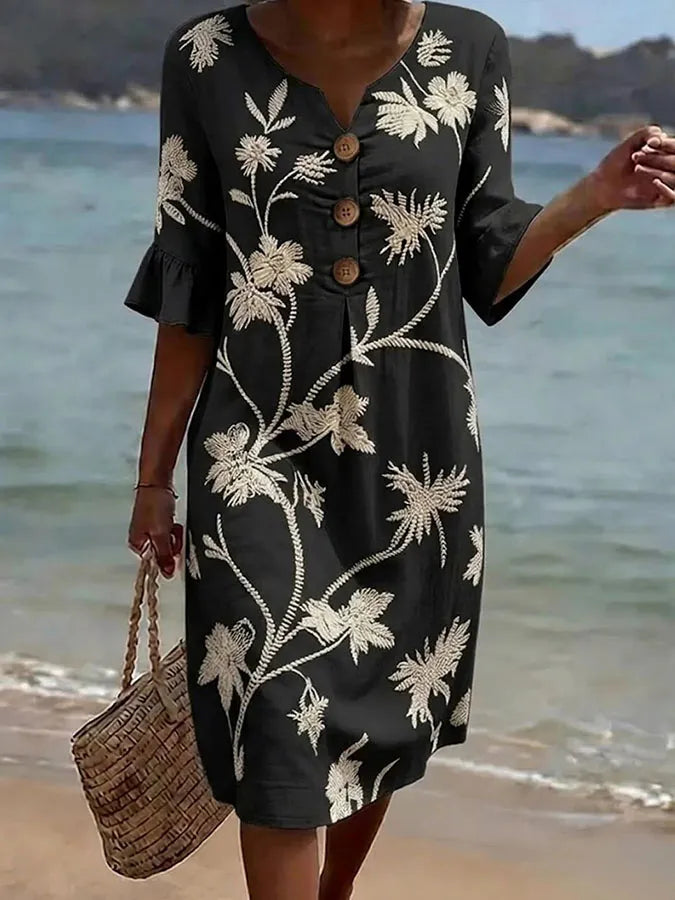 Black floral print casual dress with wooden buttons and ruffled half sleeves, full-length front view