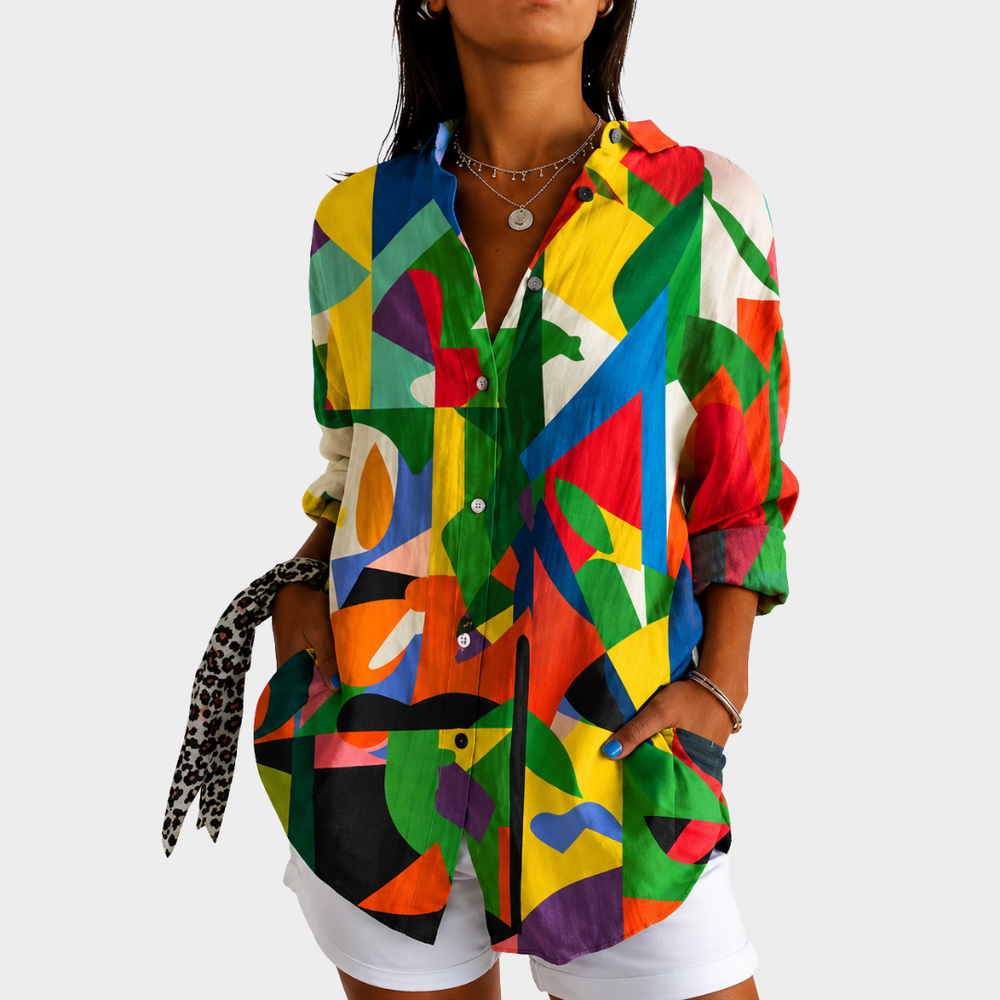 Colourful paint splash blouse in multicoloured abstract print, front view worn with white shorts
