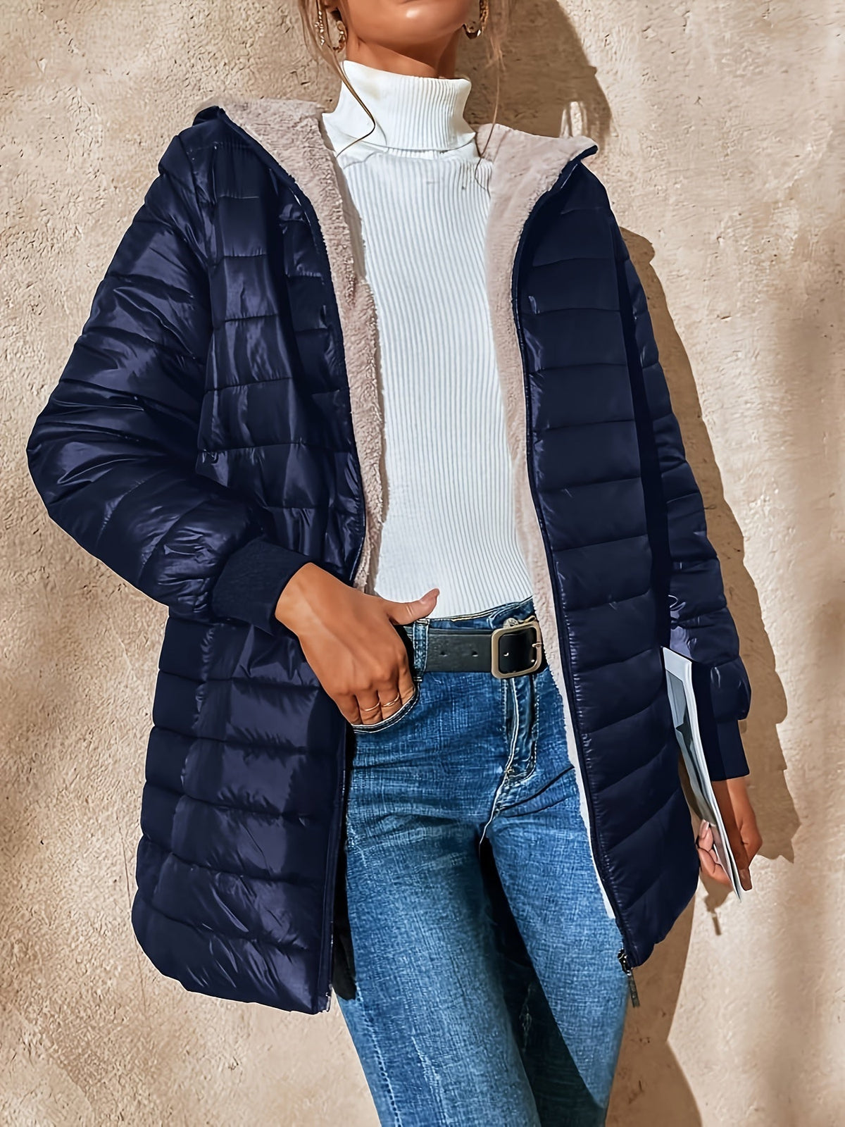 Lunera waterproof quilted jacket in navy blue, worn open over a white top