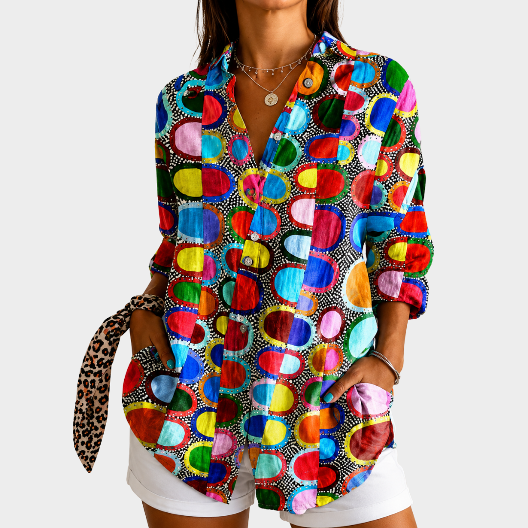Colourful circles blouse in multicoloured print, front view worn with white shorts