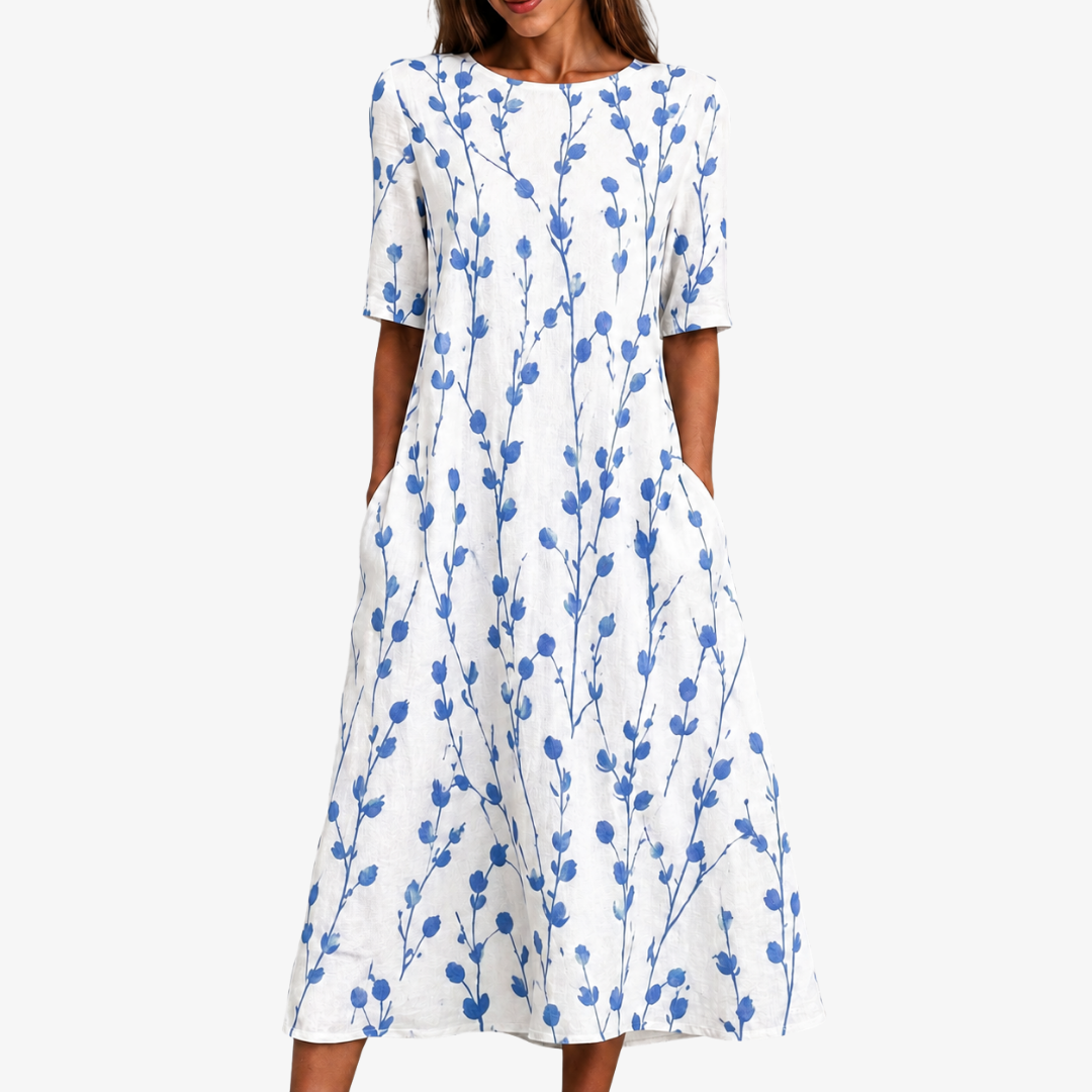 Blue Meadow Breeze pocket midi dress in white with blue botanical print, front view