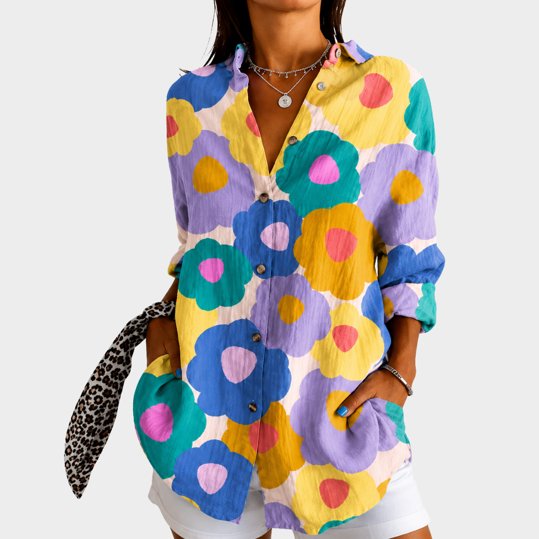 Pastel floral blouse in multicoloured bloom print, front view worn with white shorts
