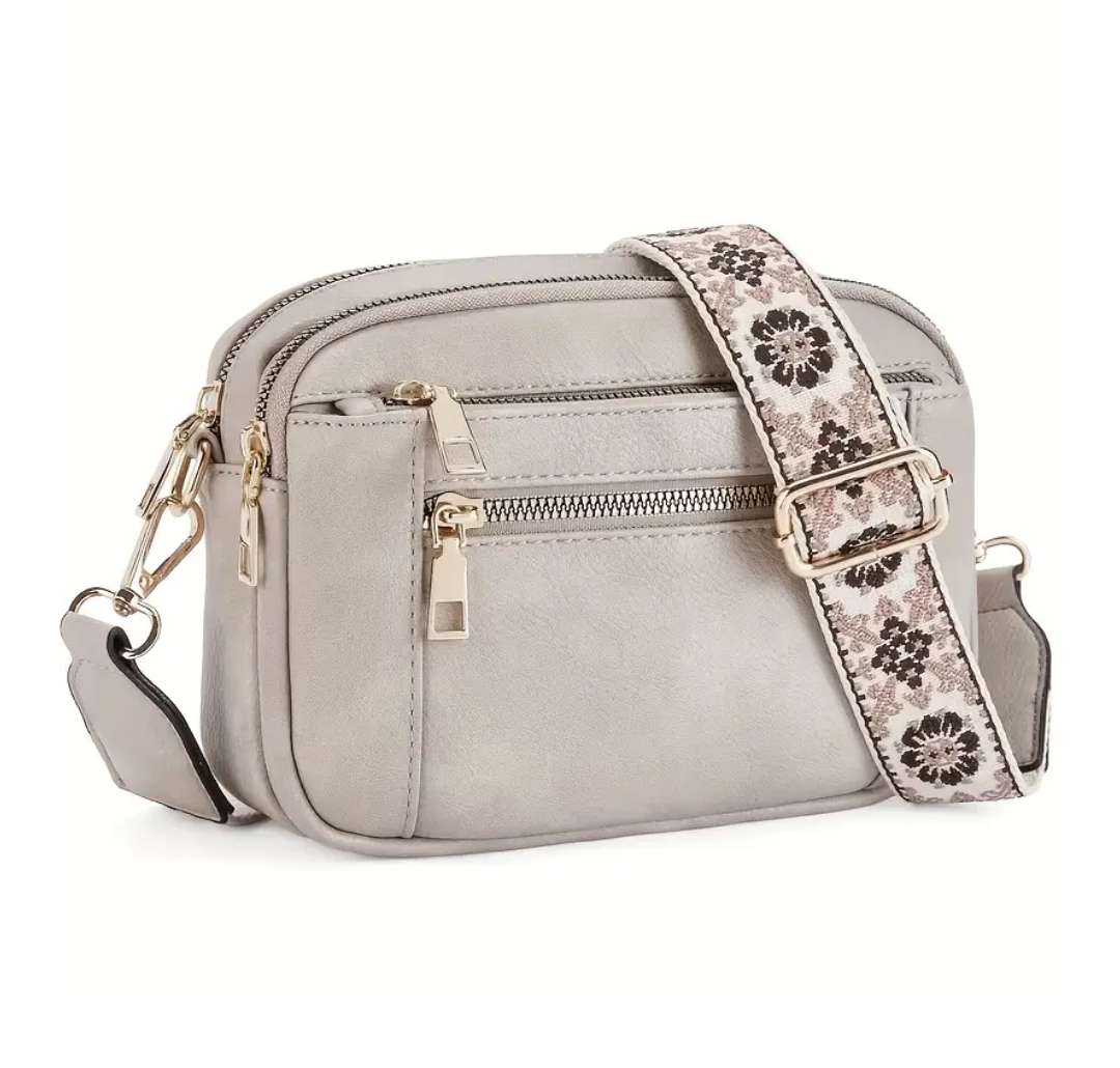 Strap crossbody bag in grey with patterned strap, side view