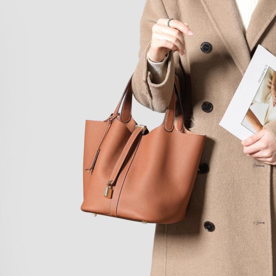 Kate lock bag in brown, carried by a model