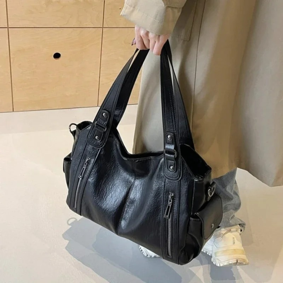 Casual shoulder bag in black, held by the twin handles
