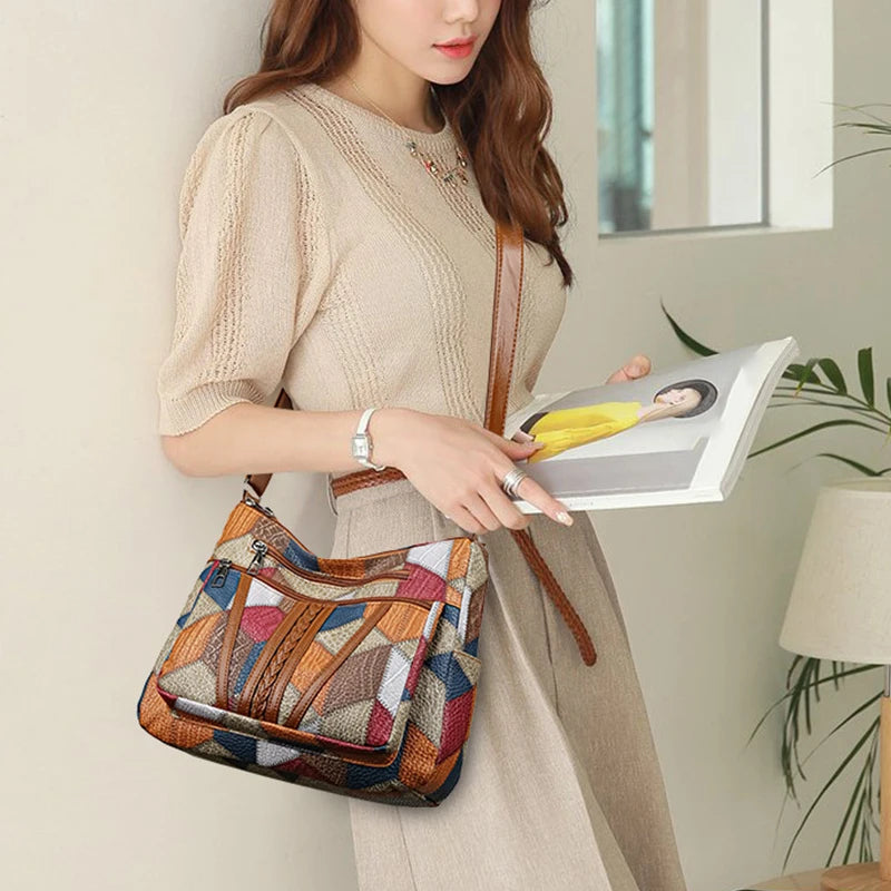 Model wearing patchwork handbag cross-body with cream knit top