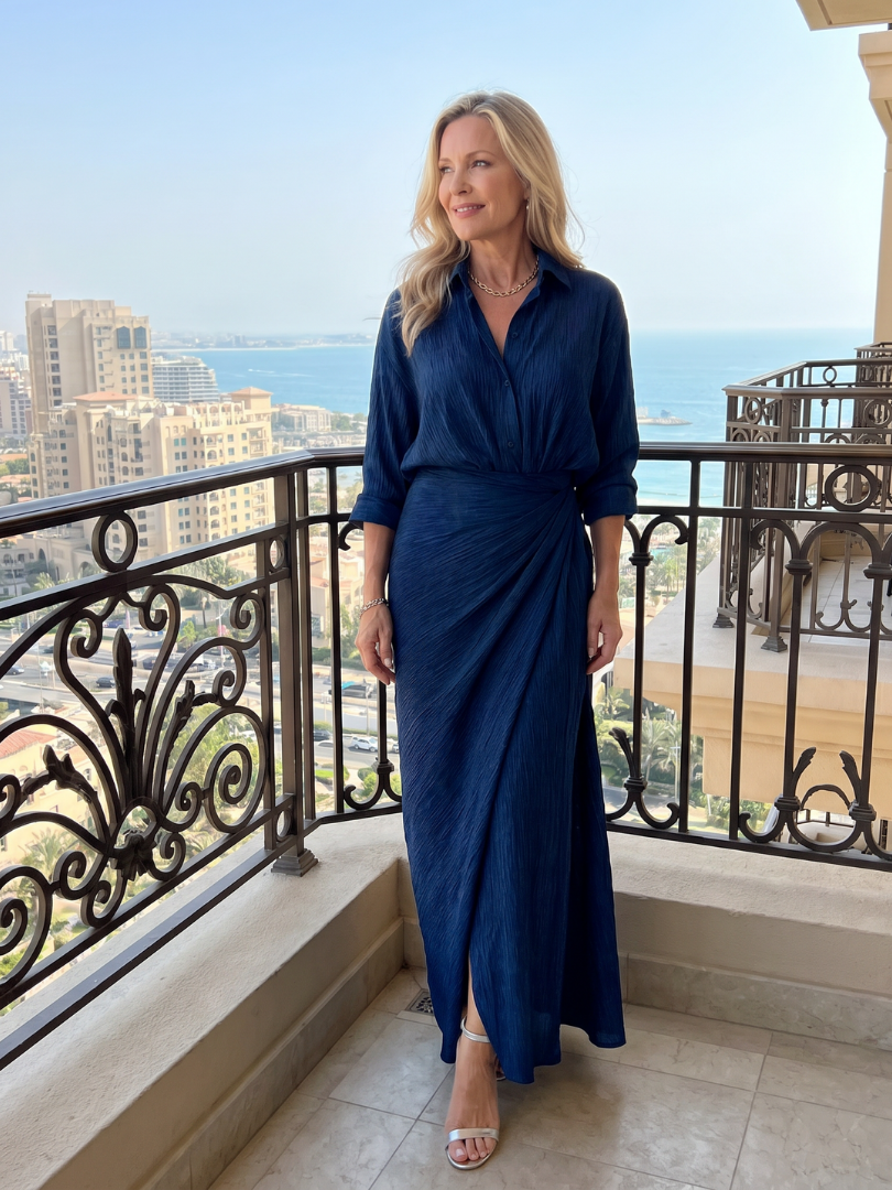 Mirque long sleeve maxi dress in navy, worn on a sunny balcony