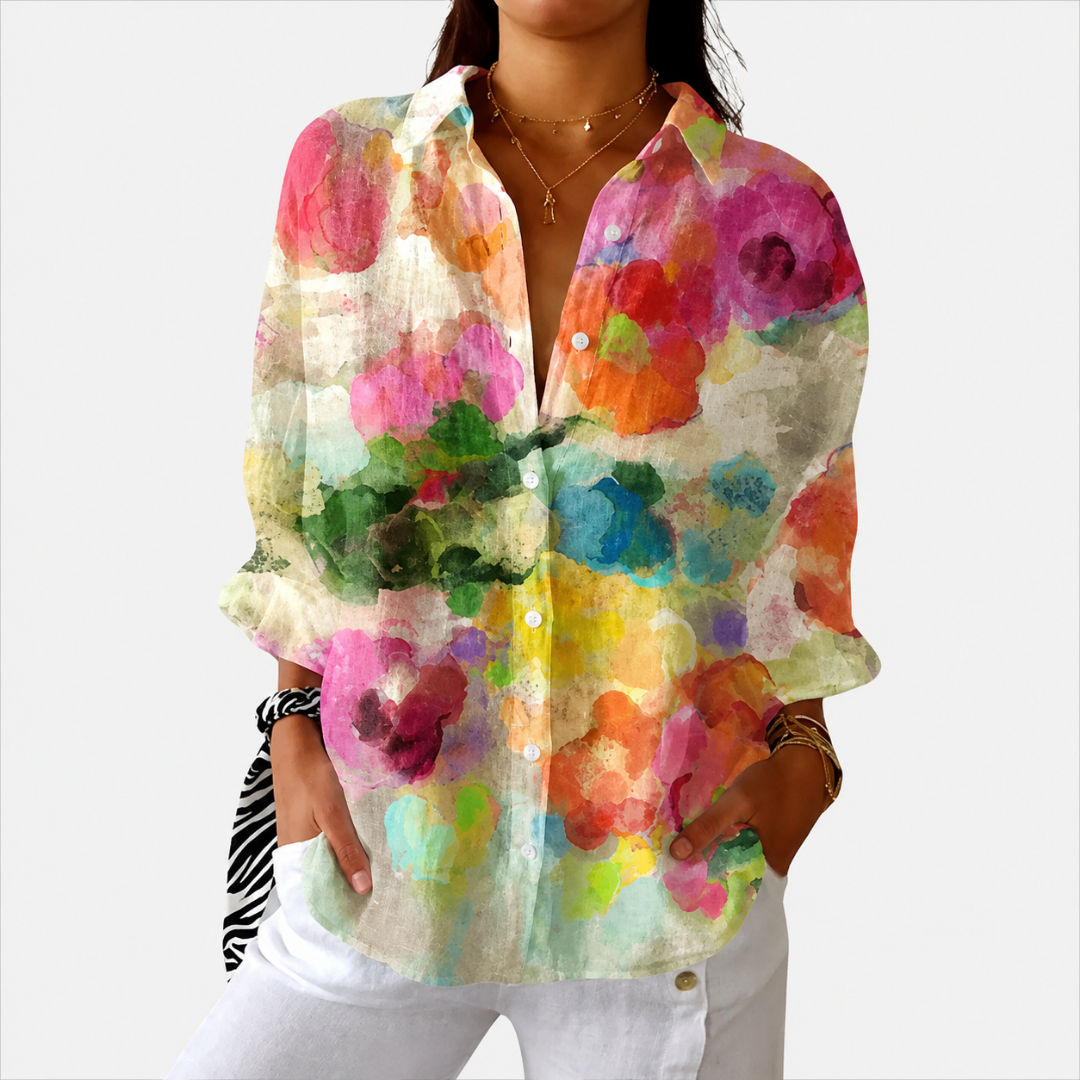 Vivid printed blouse in multicoloured watercolour floral, front view worn with white trousers
