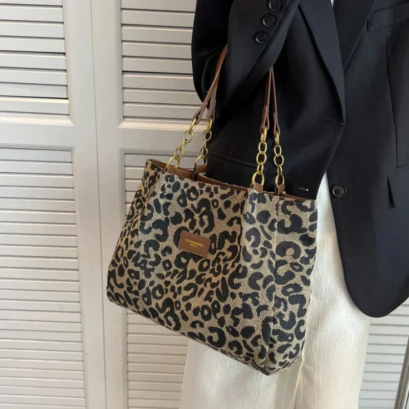 Tavira leopard tote bag held at the side with chain handles
