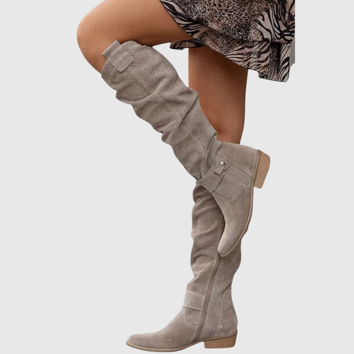 Elvoria knee-high boots in khaki suede, worn with a printed skirt