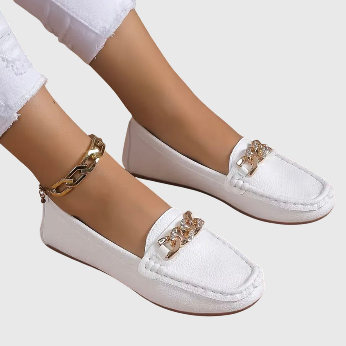 Madeleine chain-trim loafers in white, worn with white jeans