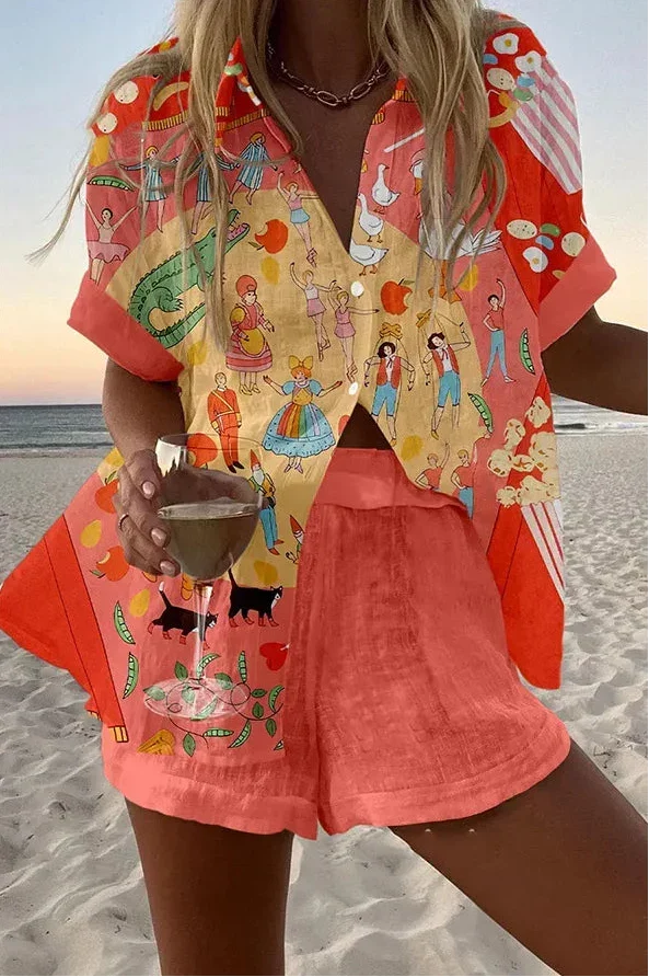 Fable summer co-ord set in coral illustrated print, shirt and shorts worn on the beach