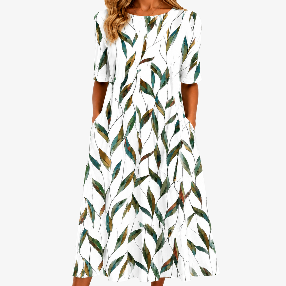 Willow Meadow botanical midi dress in white with green leaf print, front view with pockets