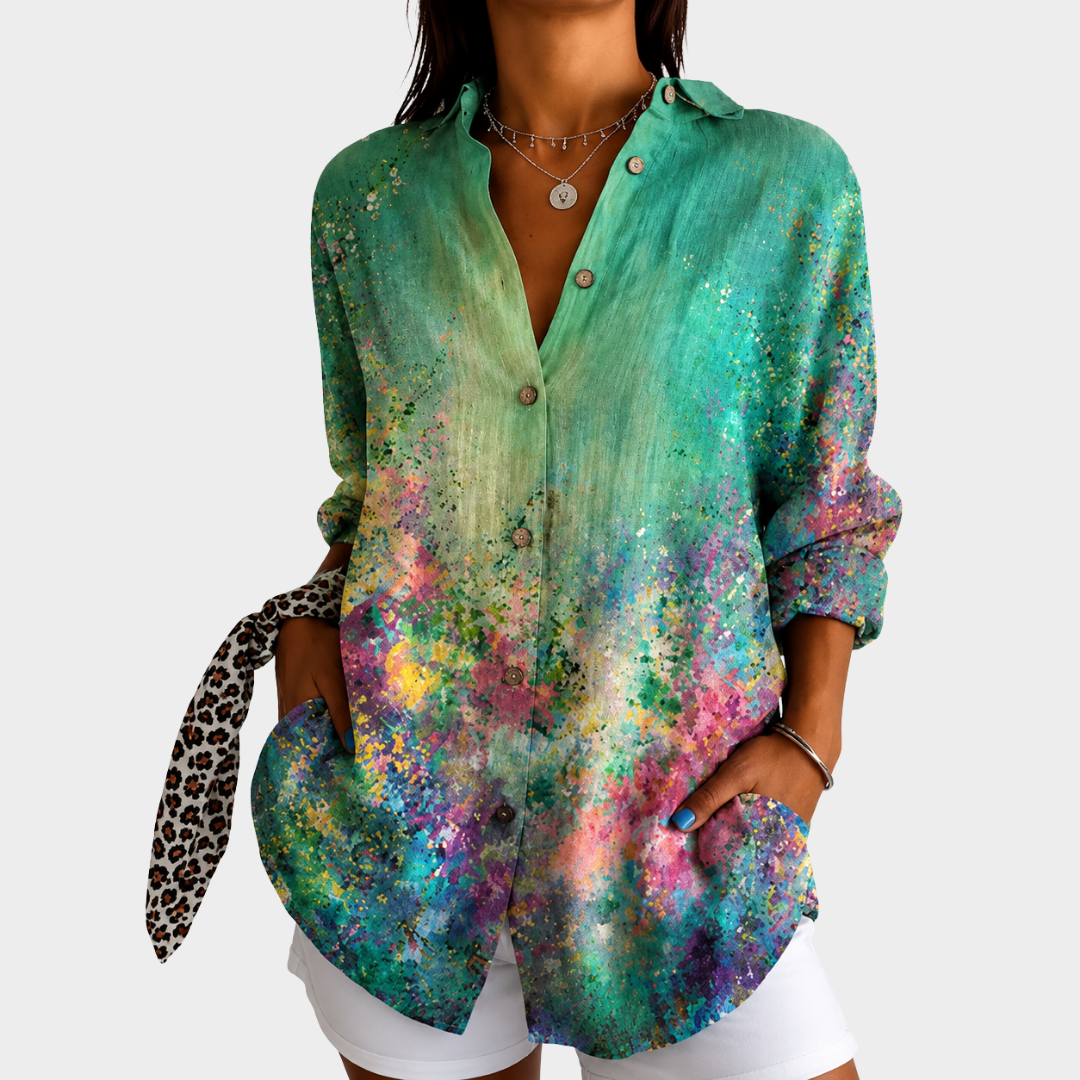 Emerald green print blouse with watercolour splatter pattern, front view worn with white shorts