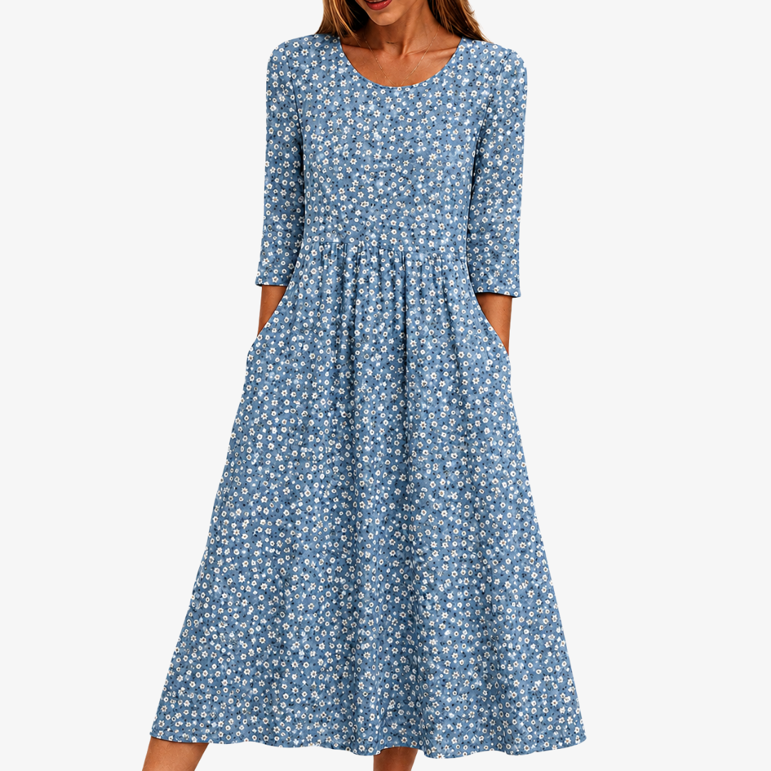 Blue Meadow floral midi dress in soft blue, front view with side pockets