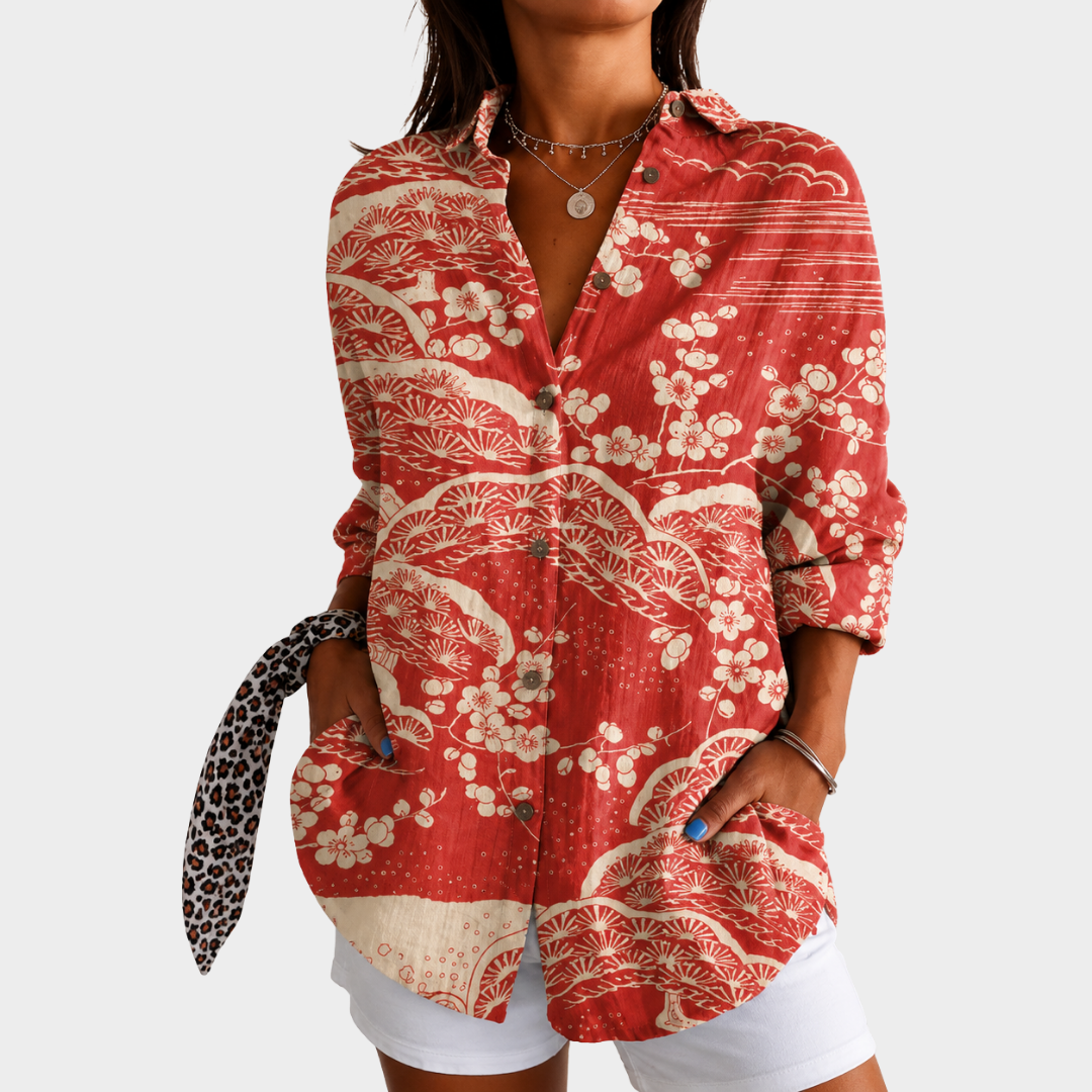 Sunset-tone floral blouse in red and cream, front view worn with white shorts