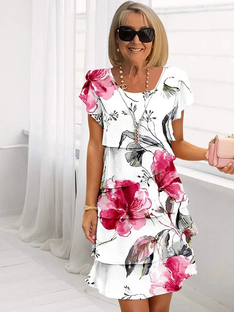 Giselle tiered ruffled dress in white with pink floral print, full front view
