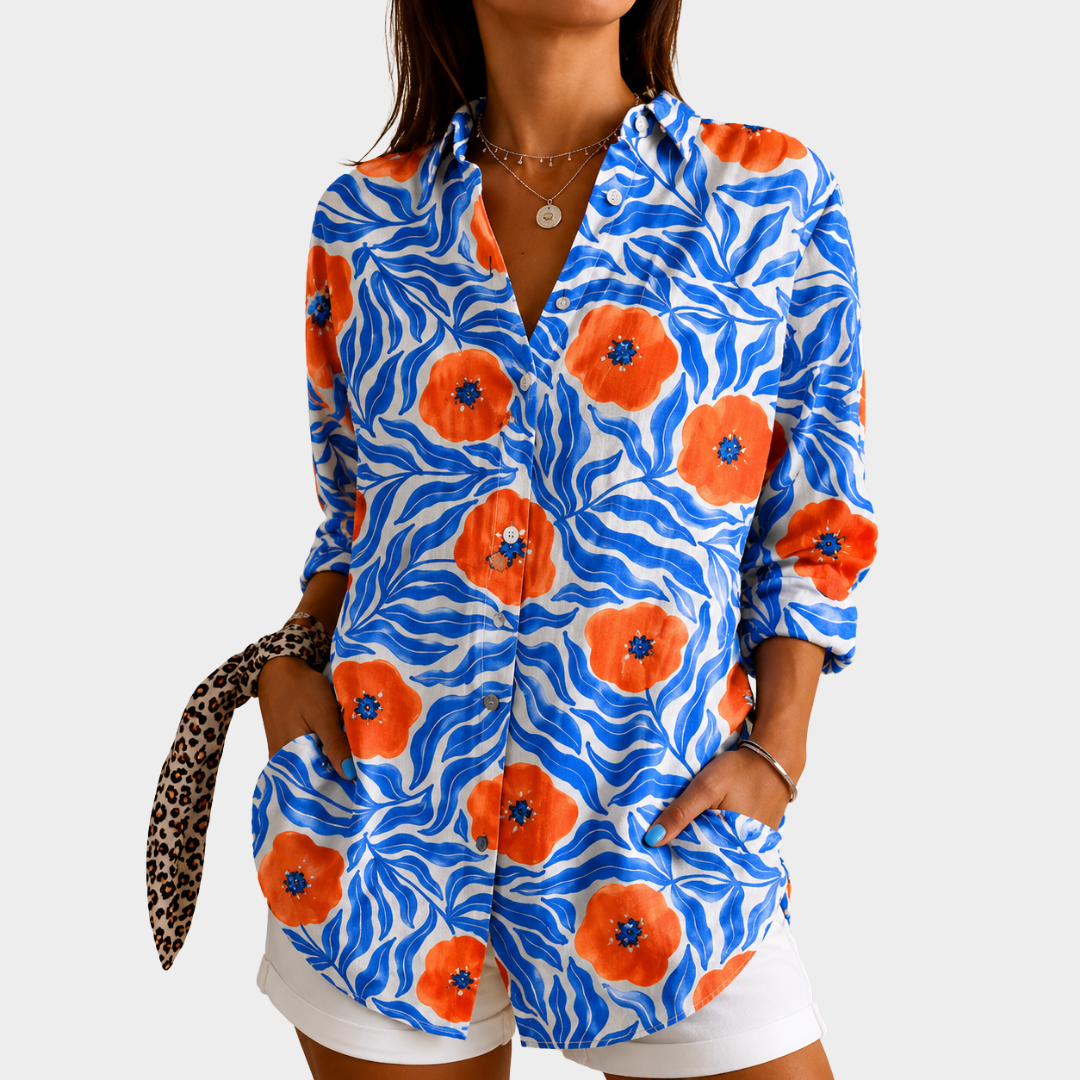Coastal blue floral blouse with orange poppy print, front view worn with white shorts
