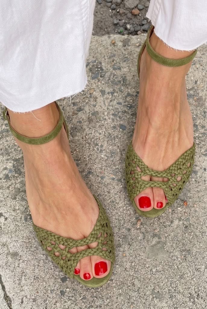 Isadora woven sandals in olive green, front view on pavement