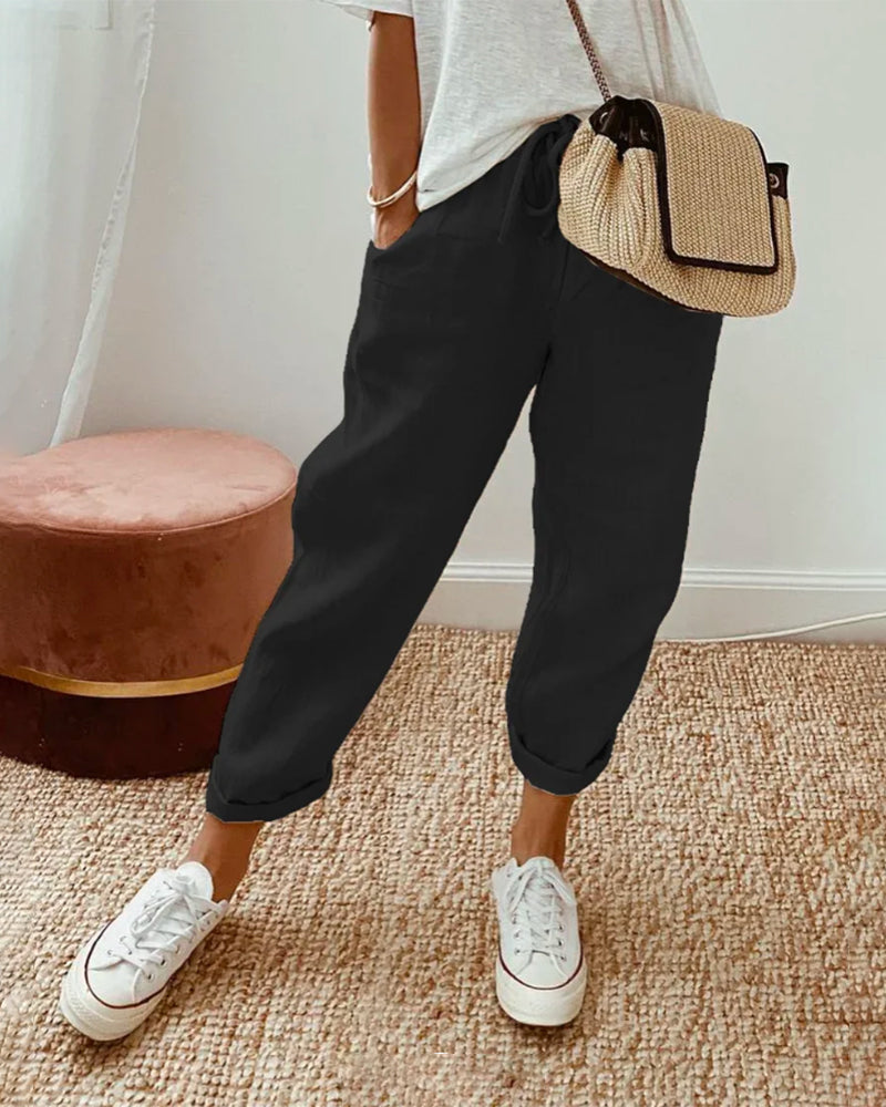 Agatha relaxed summer trousers in black, front view worn with white trainers
