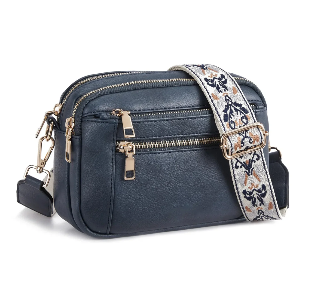 Strap crossbody bag in navy blue with woven patterned strap, side view