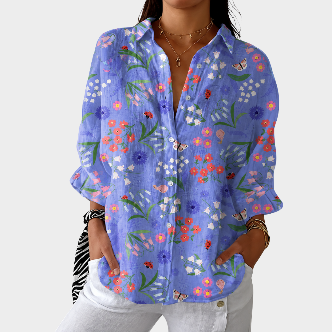 Relaxed fit small print blouse in blue floral, front view worn with white trousers