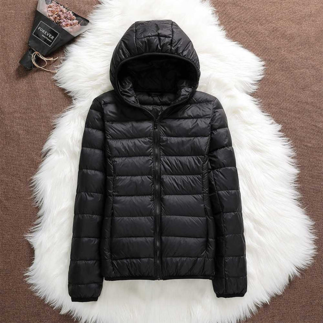 Metta padded jacket in black laid flat, showing hood and zip